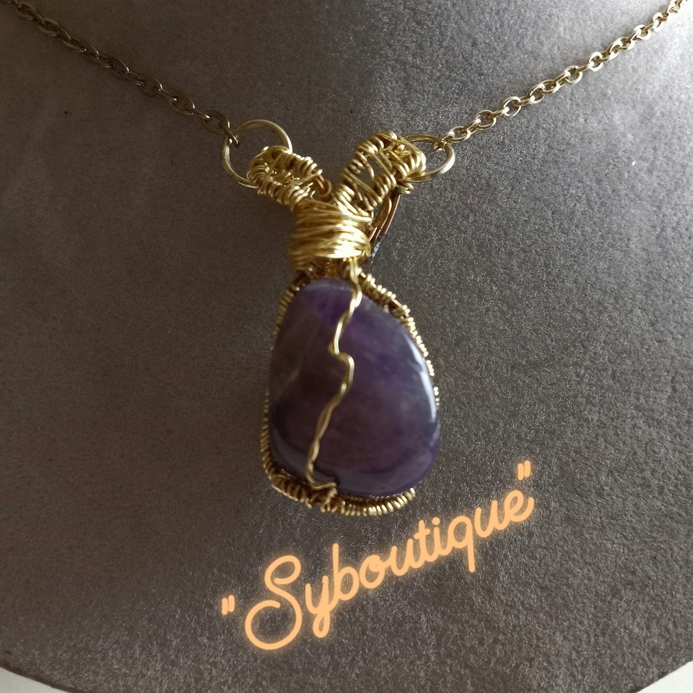 Handmade polished amethyst wire wrapped pendant.